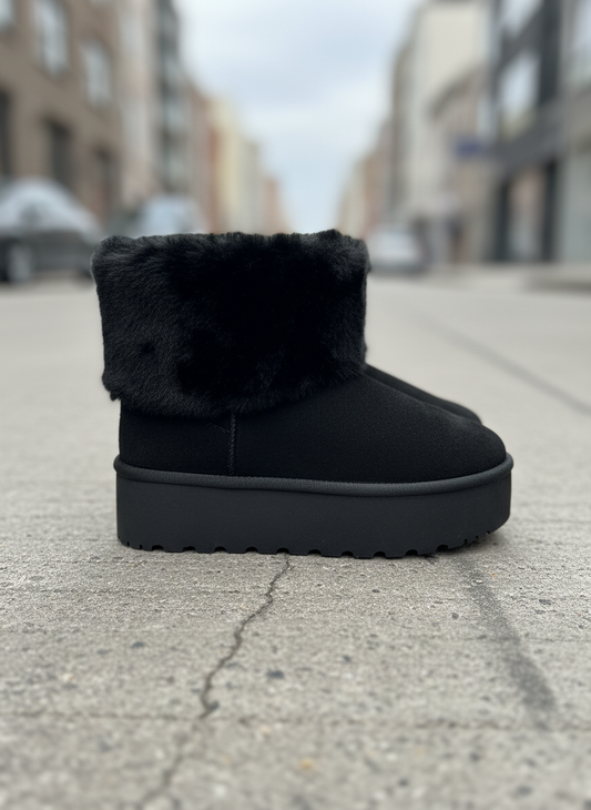 Black winter boots side view on street